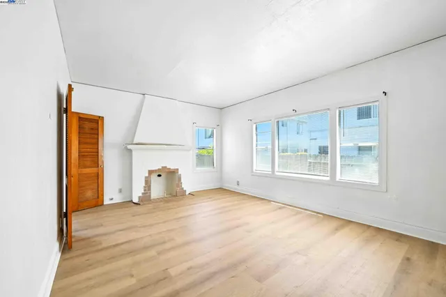 an empty room with windows and closet