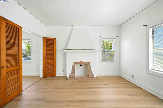 an empty room with windows and closet