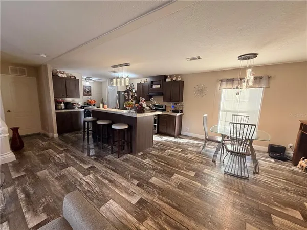 a view of a dining room with furniture and a chandelier