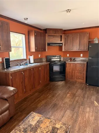 a view of entryway with a window and wooden floor