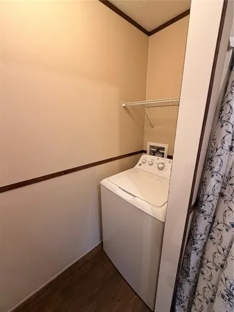 a view of a backyard with wooden fence and trees