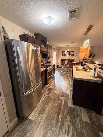 a kitchen with a sink and wooden floor