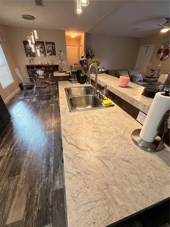 a kitchen with stainless steel appliances granite countertop a sink and a refrigerator