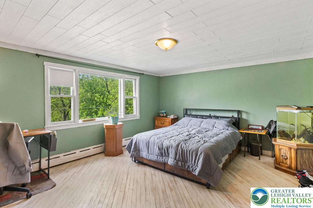1644 Moselem Spring Road Hamburg, PA 19526 - Photo 15 of 24 a bedroom with a bed and large windows