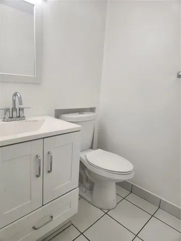 a white toilet sitting next to a bathroom sink