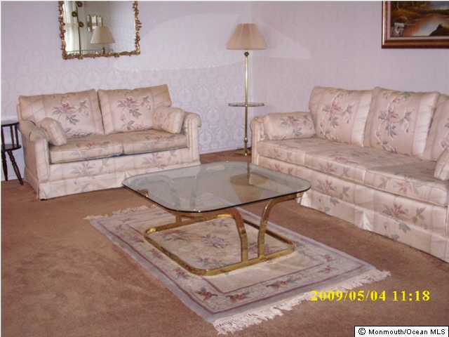 34B Mill Road, Unit B Whiting, NJ 08759 - Photo 1 of 3 a living room with couches and a coffee table