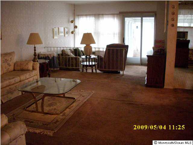 34B Mill Road, Unit B Whiting, NJ 08759 - Photo 2 of 3 a living room with furniture a window and a lamp