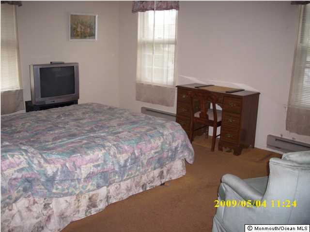 34B Mill Road, Unit B Whiting, NJ 08759 - Photo 3 of 3 a bedroom with a bed and a window