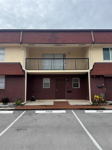 a couple of cars parked in front of a building