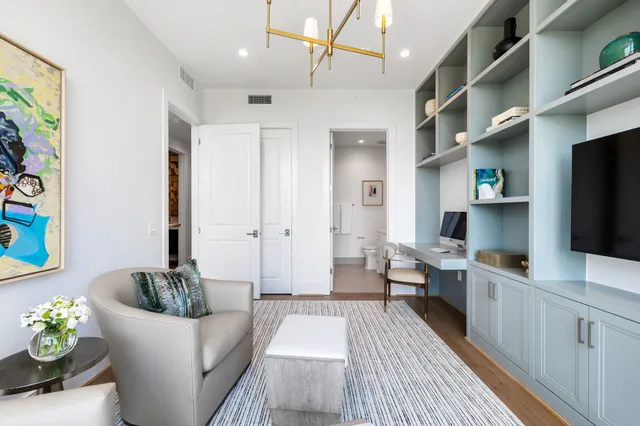 a living room with lots of furniture and a large window