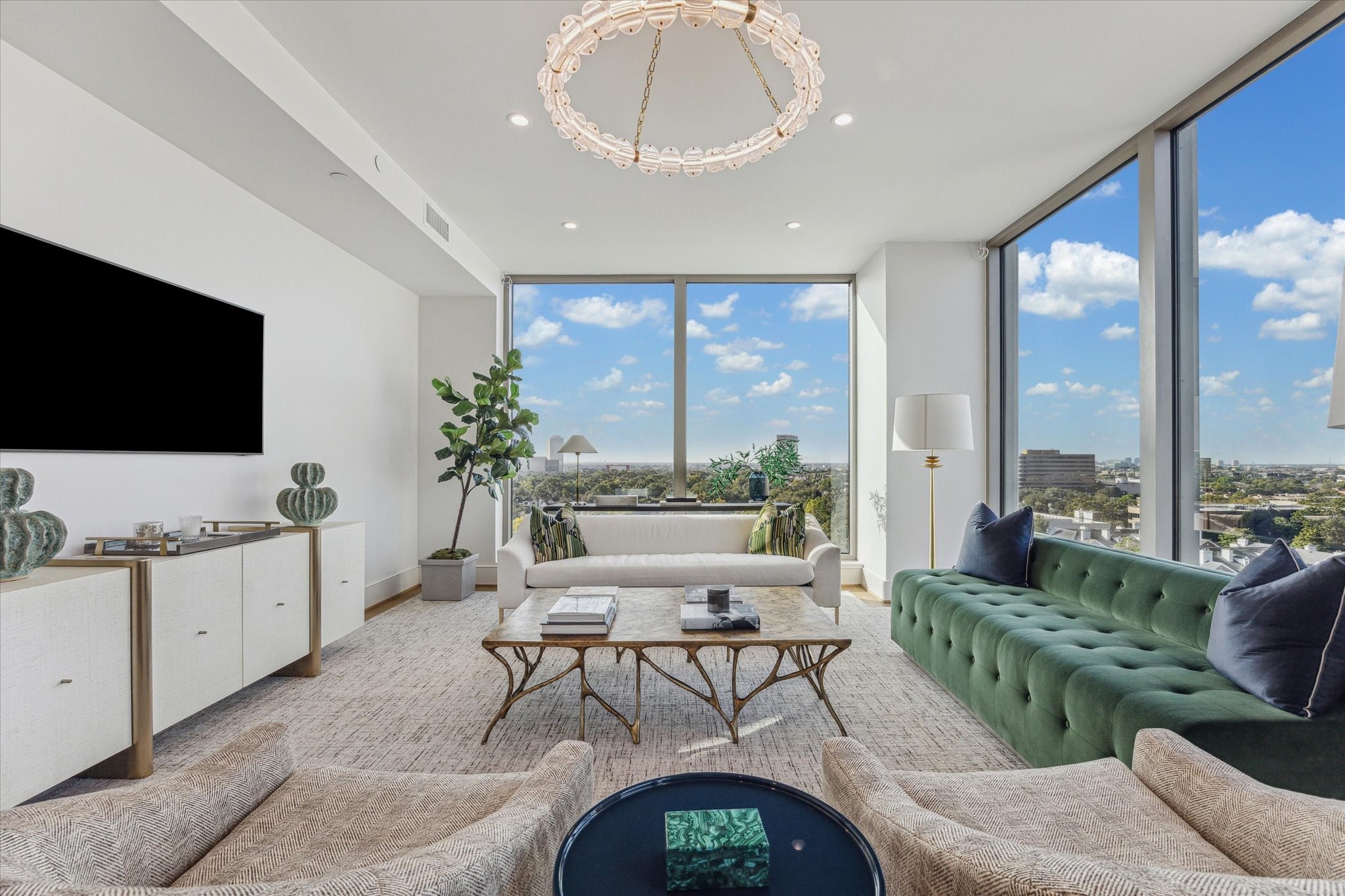 5656 San Felipe Street, Unit 1205 Houston, TX 77056 - Photo 19 of 45 a living room with furniture a flat screen tv and a floor to ceiling window