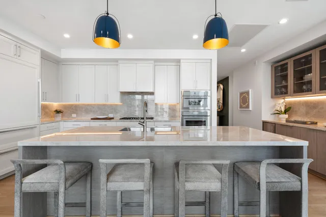 a large bedroom with a bed and a large window