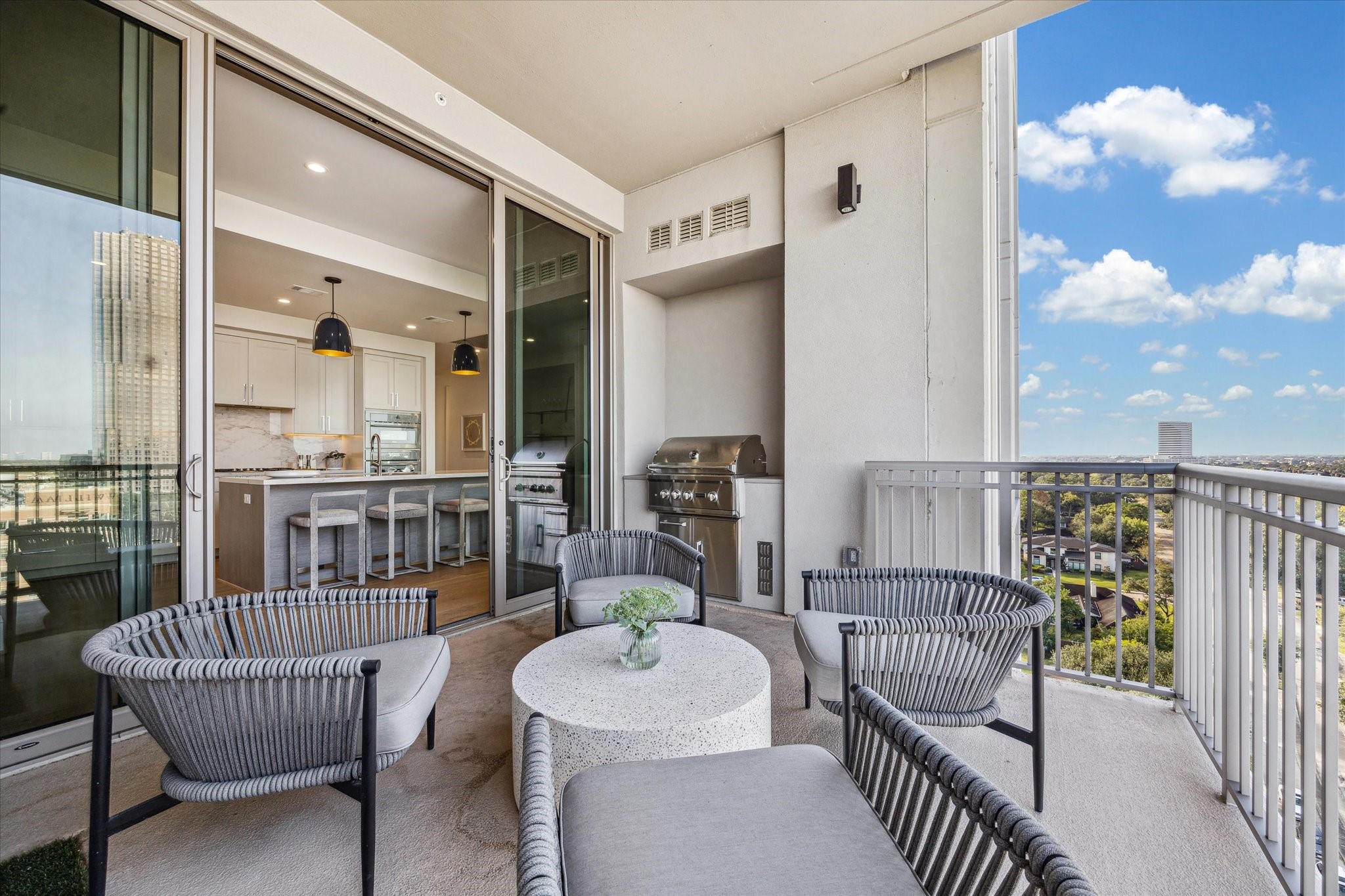 5656 San Felipe Street, Unit 1205 Houston, TX 77056 - Photo 22 of 45 Balcony shown with sliding doors open to the kitchen for seamless indoor–outdoor living. Photos are of a similar unit with the same floor plan