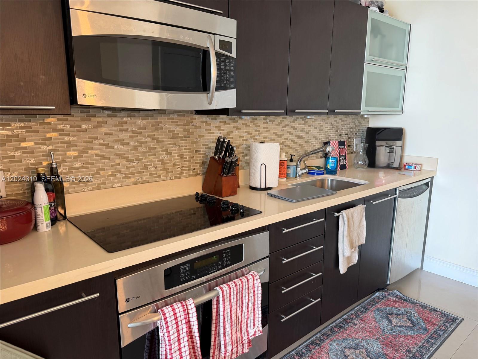90 Southwest 3rd Street, Unit 1409 Miami, FL 33130 - Photo 7 of 25 a kitchen with a sink and cabinets