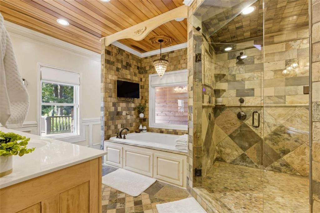 1091 Echota Road Clarkesville, GA 30523 - Photo 18 of 89 a bathroom with a granite countertop sink a mirror and shower