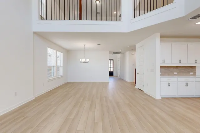 a view of a kitchen with wooden floor and windows