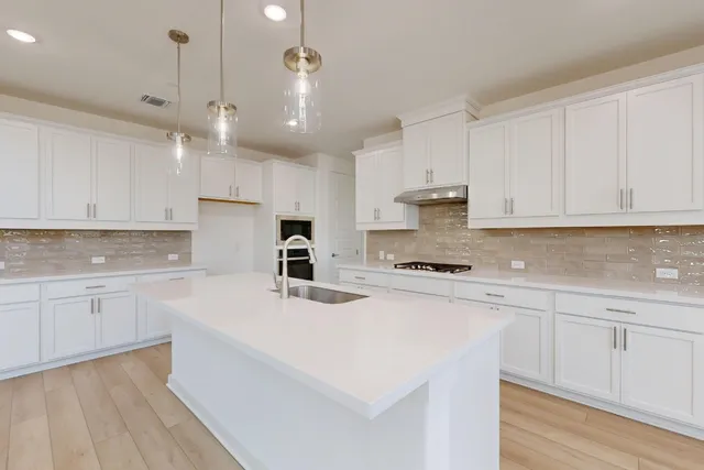 a kitchen with kitchen island white cabinets and white appliances