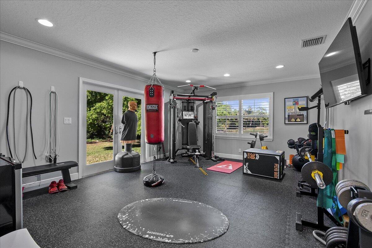 10975 Randolph Siding Road Jupiter, FL 33478 - Photo 68 of 97 a view of a room with gym equipment