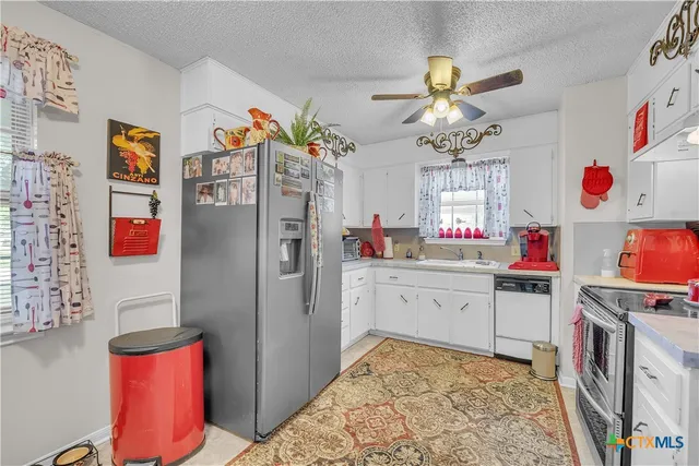 a kitchen with stainless steel appliances granite countertop a refrigerator and stove