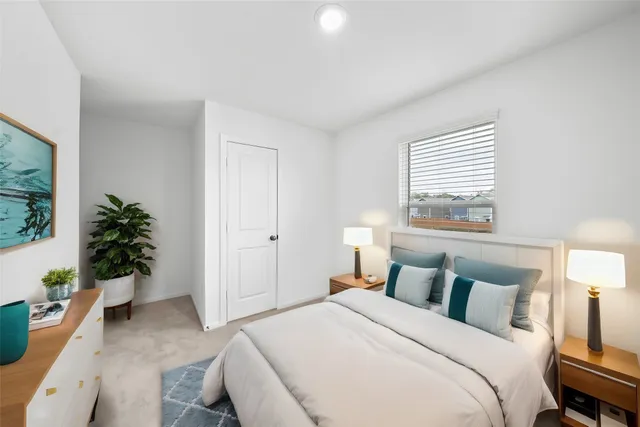 a bedroom with a bed and a potted plant