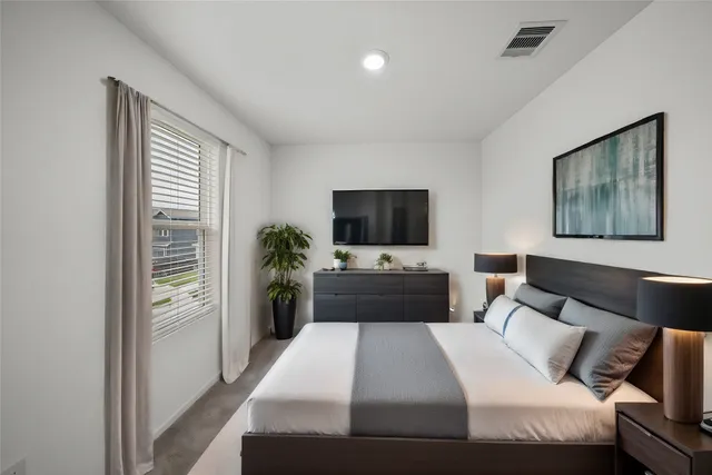 a bedroom with a bed and a flat screen tv