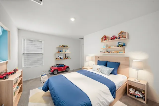 a bedroom with a bed and a couch