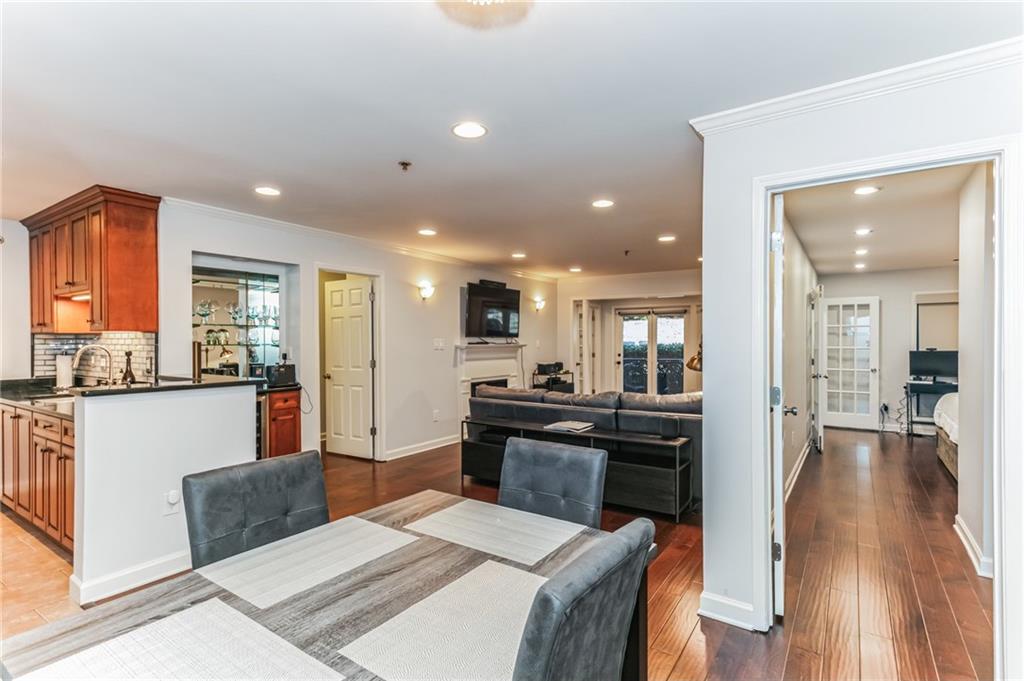 3203 Lenox Road Northeast, Unit 1 Atlanta, GA 30324 - Photo 2 of 12 a living room with stainless steel appliances kitchen island granite countertop furniture wooden floor and a kitchen view