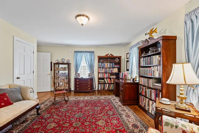 a living room with furniture a rug and a flat screen tv
