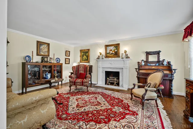 a living room with furniture a rug and a flat screen tv
