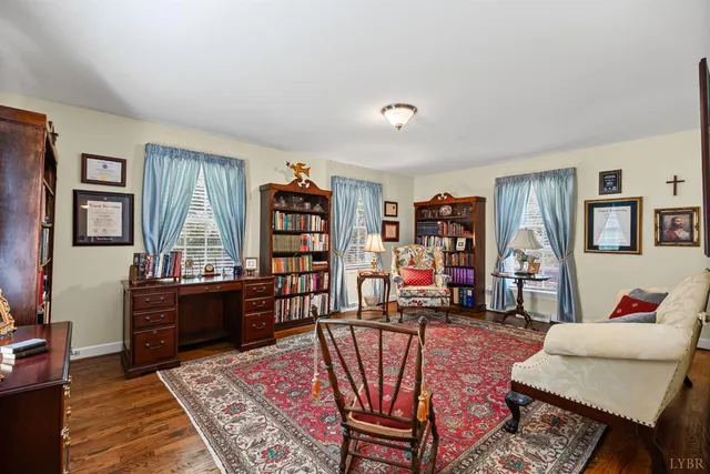 a living room with furniture a rug and a book shelf