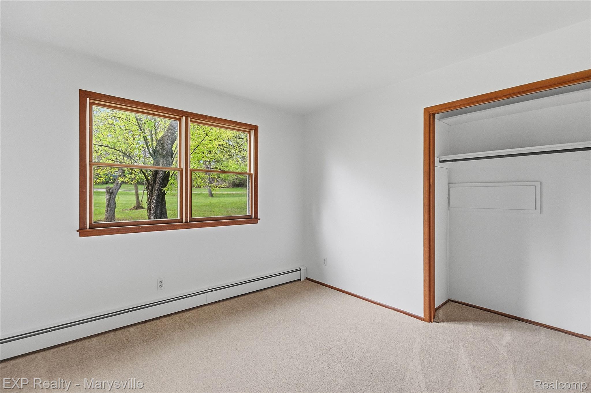3345 Beach Road Port Huron, MI 48060 - Photo 20 of 89 Unfurnished bedroom featuring baseboard heating, light colored carpet, and a closet