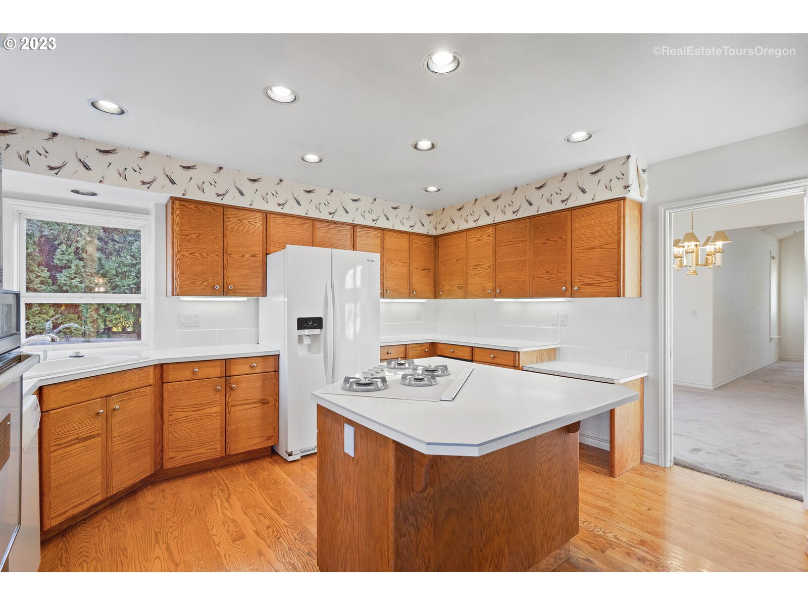 5161 Southeast Powell Valley Road Gresham, OR 97080 - Photo 4 of 32 a kitchen with stainless steel appliances granite countertop a sink a stove and a refrigerator