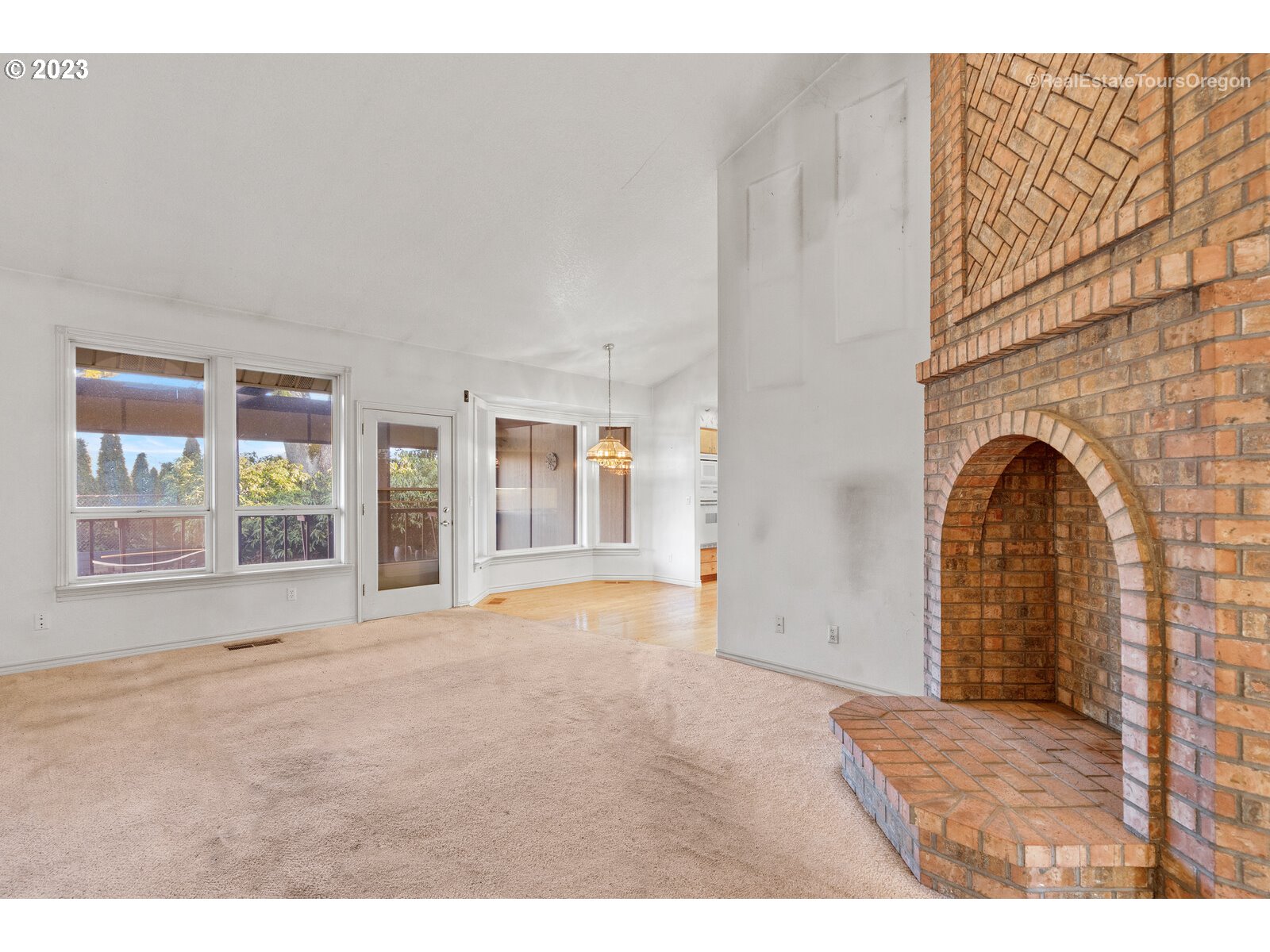 5161 Southeast Powell Valley Road Gresham, OR 97080 - Photo 8 of 32 a view of an empty room with wooden floor and windows