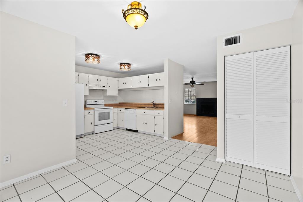 12668 Castle Hill Drive Tampa, FL 33624 - Photo 11 of 32 a kitchen with white cabinets and appliances