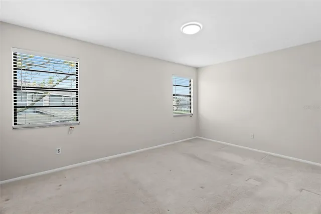 an empty room with windows and closet