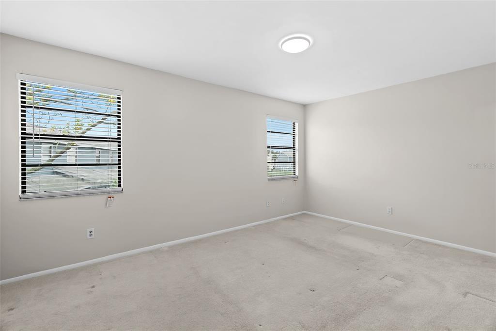 12668 Castle Hill Drive Tampa, FL 33624 - Photo 16 of 32 an empty room with windows and closet