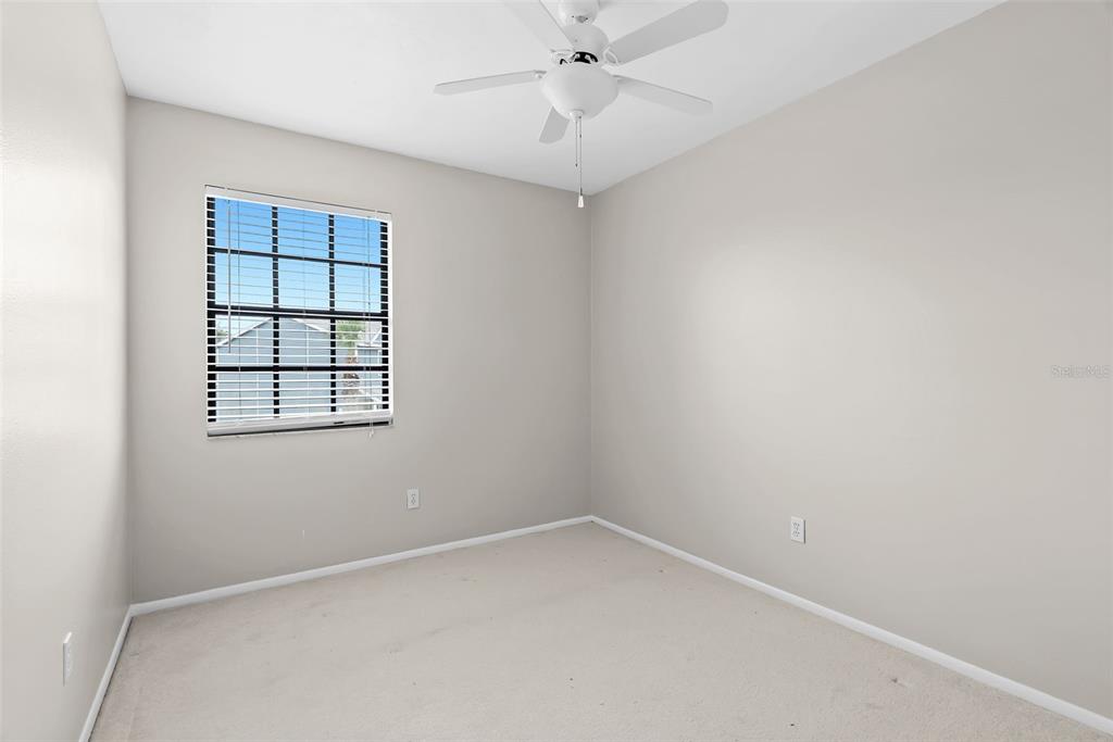 12668 Castle Hill Drive Tampa, FL 33624 - Photo 19 of 32 an empty room with a window and ceiling fan