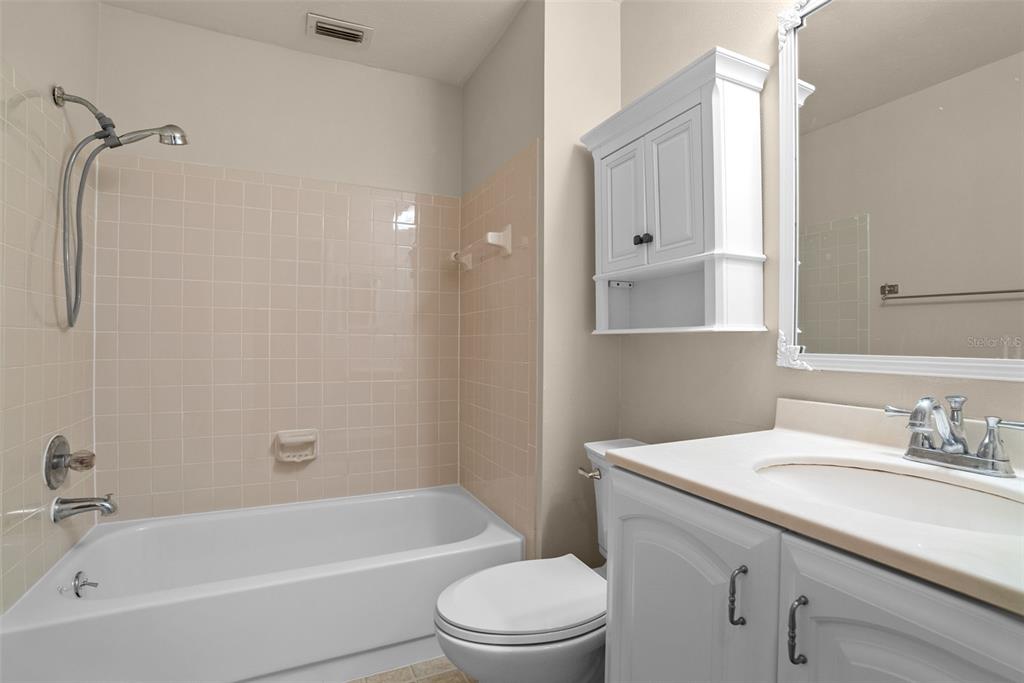 12668 Castle Hill Drive Tampa, FL 33624 - Photo 20 of 32 a bathroom with a sink toilet and shower