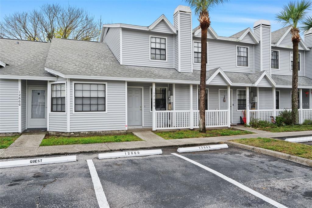 12668 Castle Hill Drive Tampa, FL 33624 - Photo 32 of 32 a front view of a house with a yard and potted plants