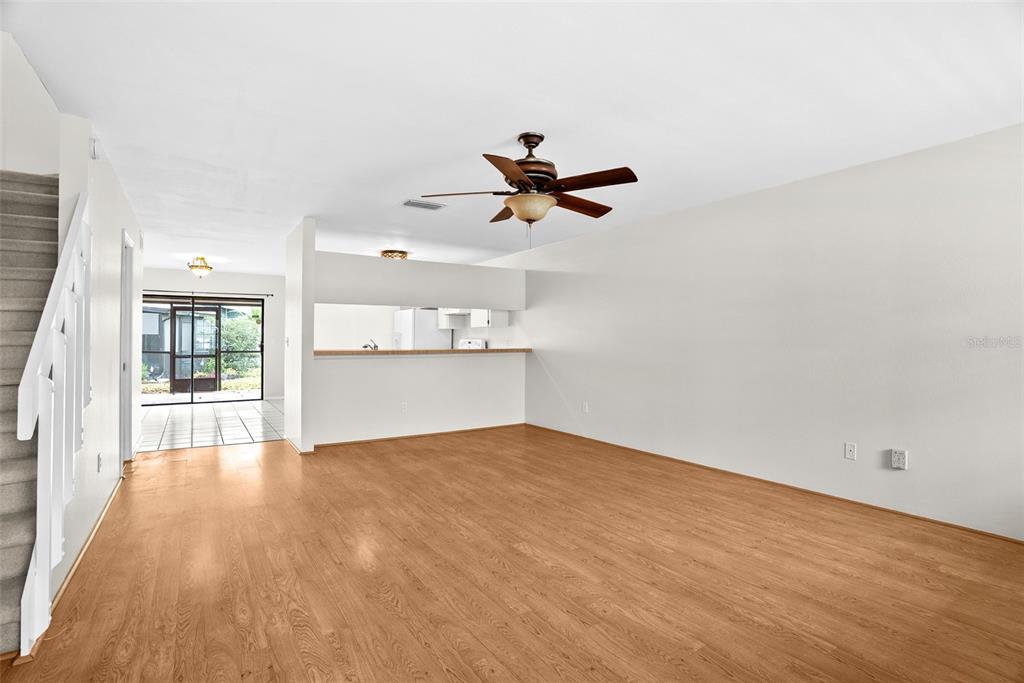 12668 Castle Hill Drive Tampa, FL 33624 - Photo 6 of 32 wooden floor in an empty room with a window