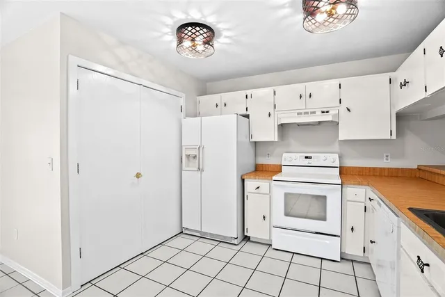 a kitchen with cabinets and appliances