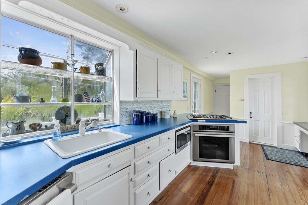 160 Clark Road Bourne, MA 02562 - Photo 31 of 42 a kitchen with stainless steel appliances a stove a sink and a refrigerator