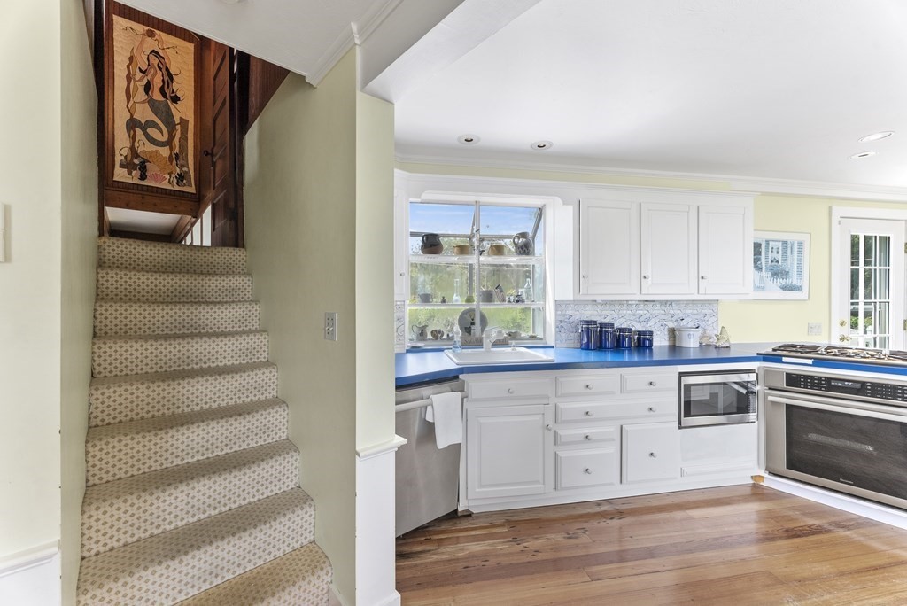 160 Clark Road Bourne, MA 02562 - Photo 33 of 42 a kitchen with cabinets and wooden floor