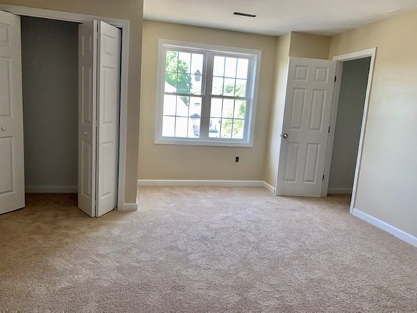 90 King Philip Road Worcester, MA 01606 - Photo 8 of 34 an empty room with windows and closet