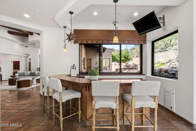 a kitchen with kitchen island granite countertop a table and chairs in it