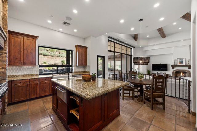 a kitchen with center island and a table in it