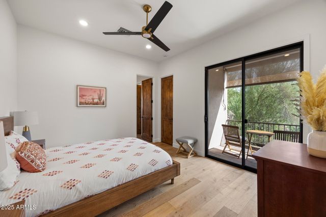 a bedroom with a large bed and a large window