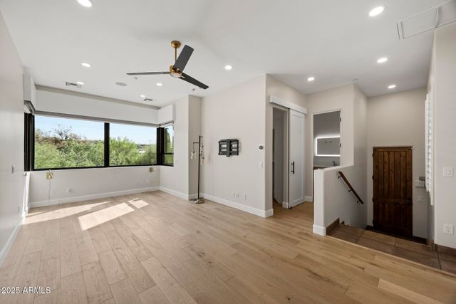 a view of livingroom with stainless steel appliances wooden floor and window