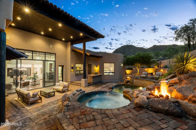 a living room with furniture a floor to ceiling window and a fireplace