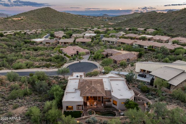 an aerial view of a houses with a city view
